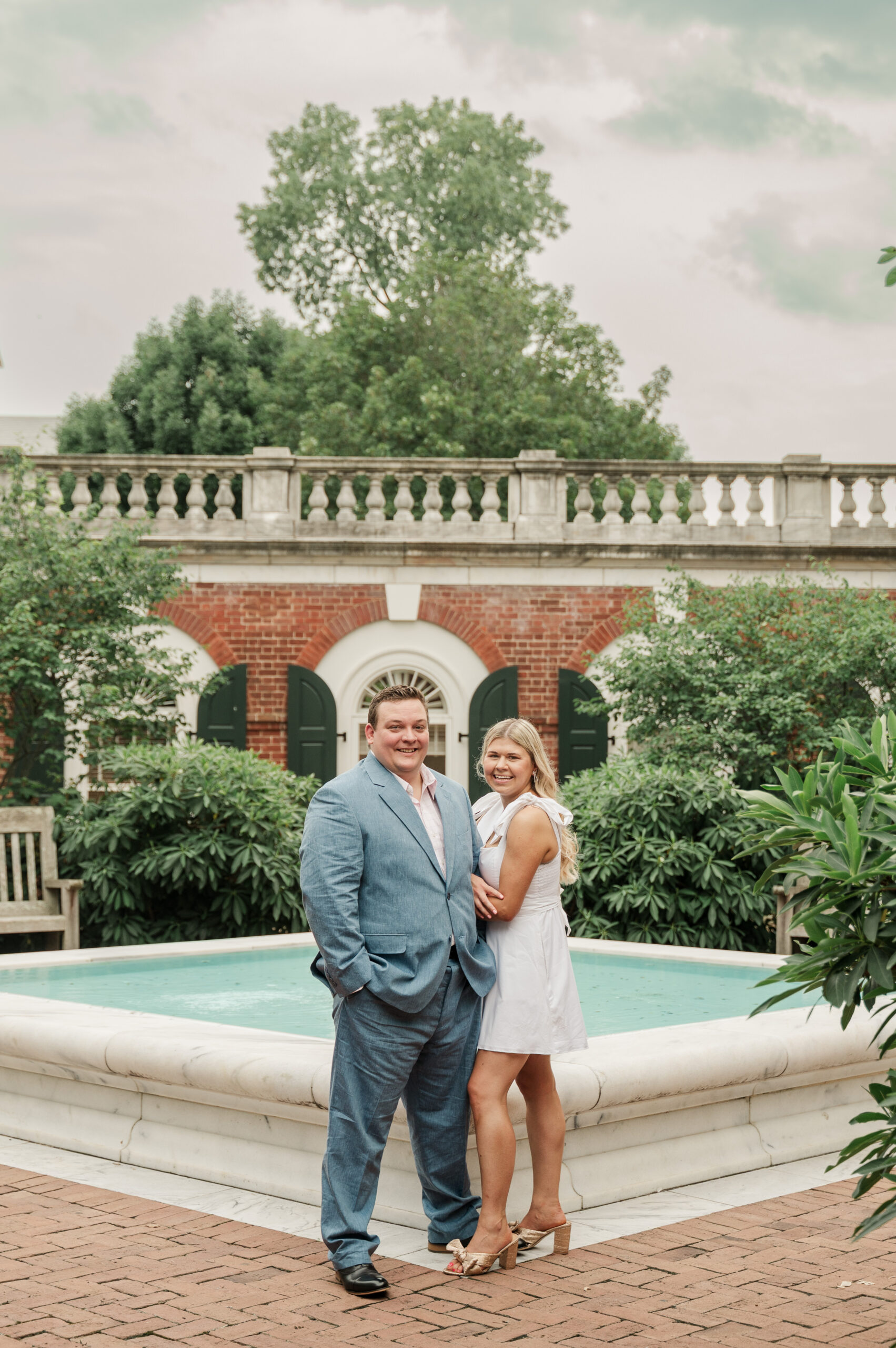 Micheala and Wade standing in front of the fountain at the Rotunda