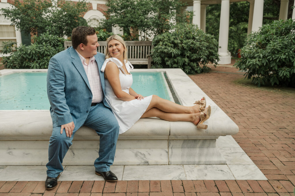 Wade & Michaela sitting on fountain at Rotunda