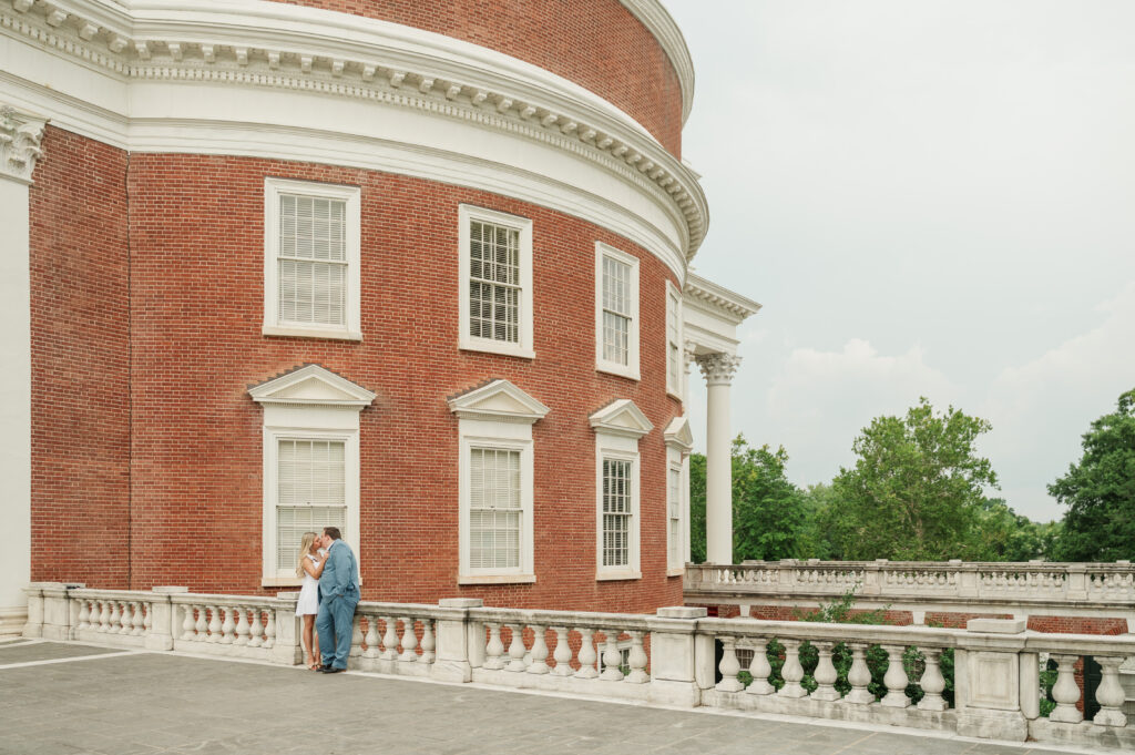 micheala and wade leaning against railing beside UVA Rotunda