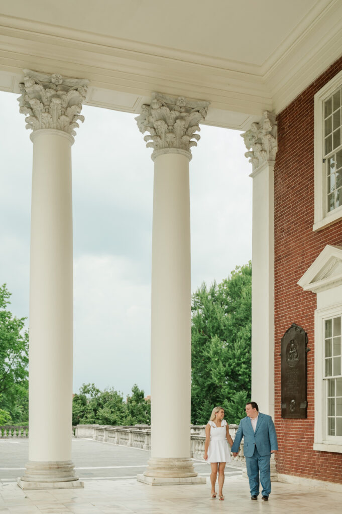 Micheala & Wade walking under the portico at UVA Rotunda