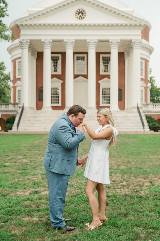 Wade kissing Micheala's hand while on Lawn at University of Virginia