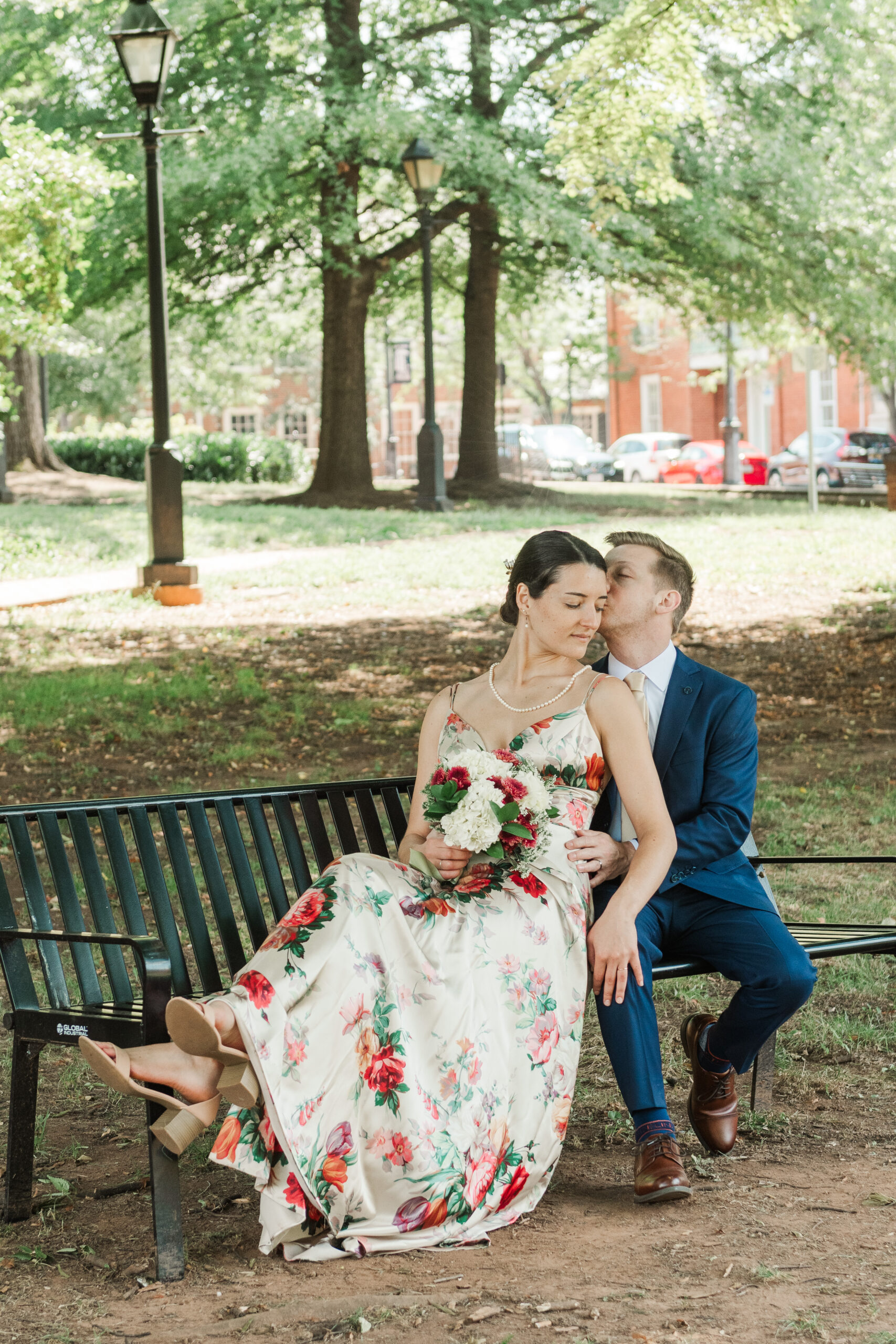 sarah leaning against nicholas while seated on bench