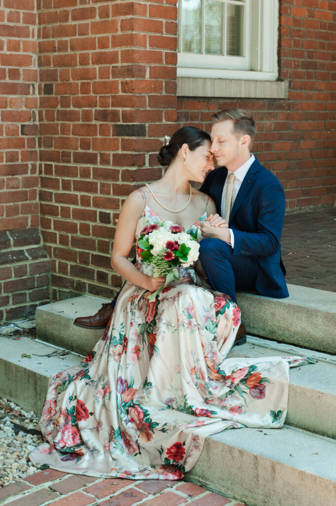 couple holding each other while seated on steps after eloping