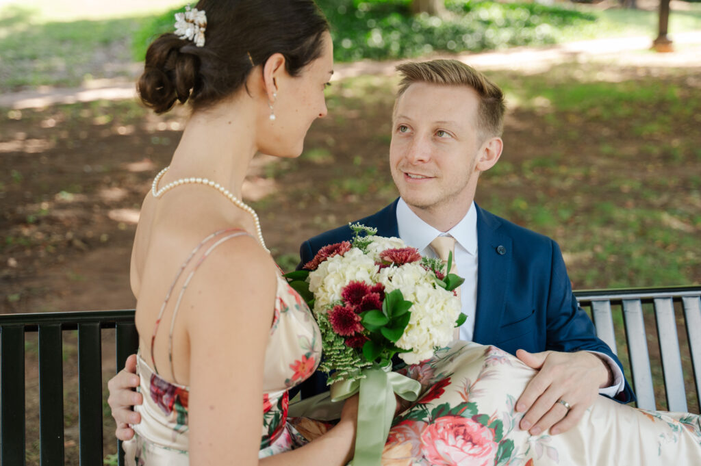 bride and groom portrait seated on bench