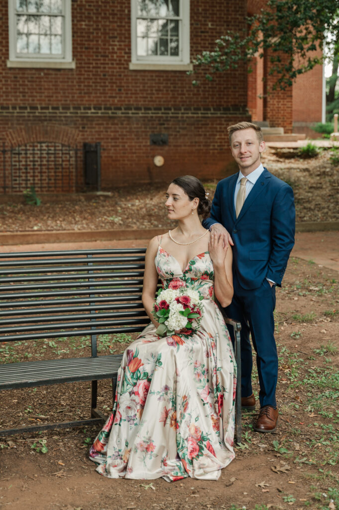 bride seated on bench in front of groom