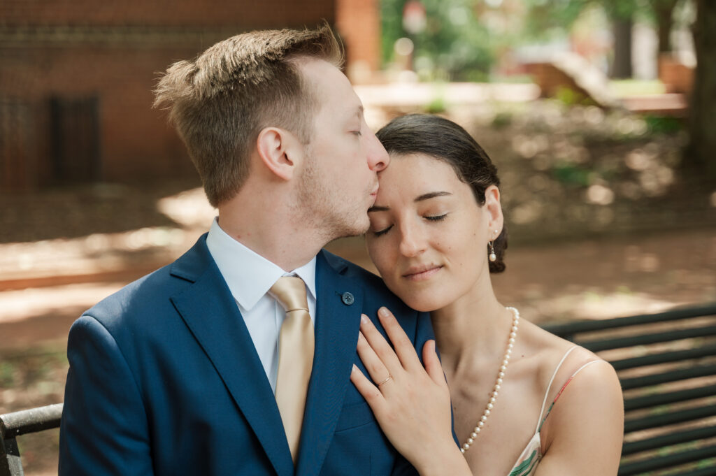 groom kissing bride's forehead during couple portraits