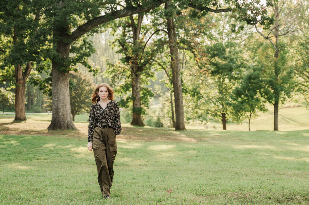 Raichyl walking in front of the tree canopy