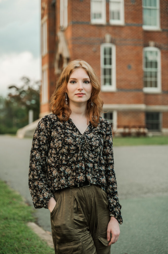 Raichyl standing in front of Caton Hall during her senior portrait session