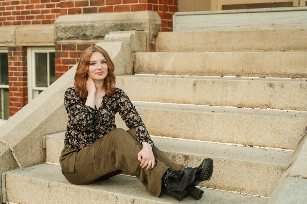 Raichyl sitting on the steps at Caton Hall during her senior session