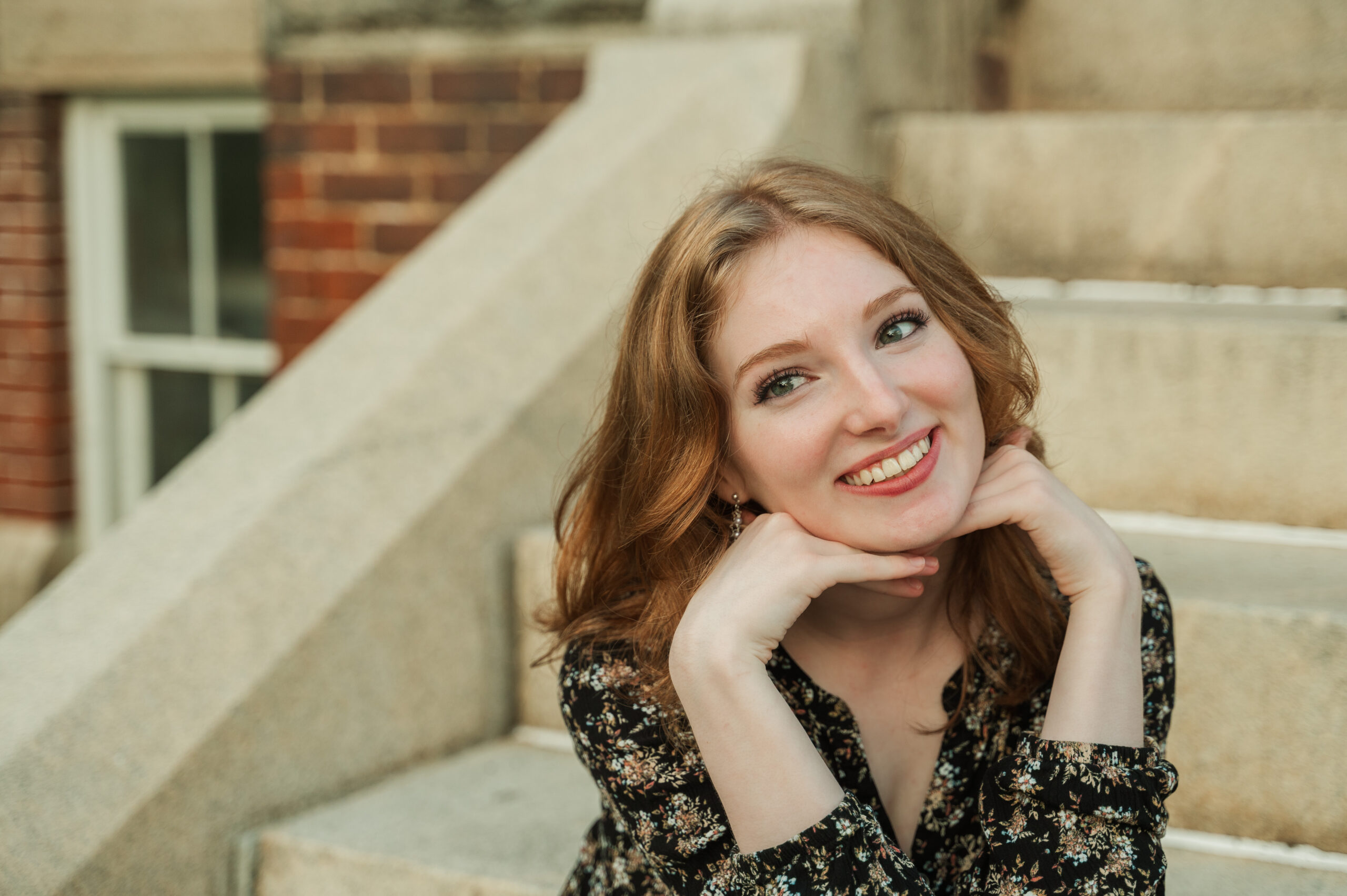 Raichyl having fun with a cut pose while sitting on steps at Caton Hall