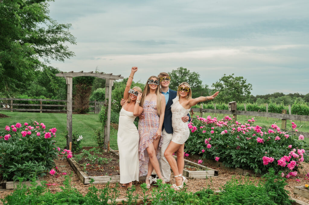 UVA grads posing with 2025 glasses at the Farmhouse at Veritas
