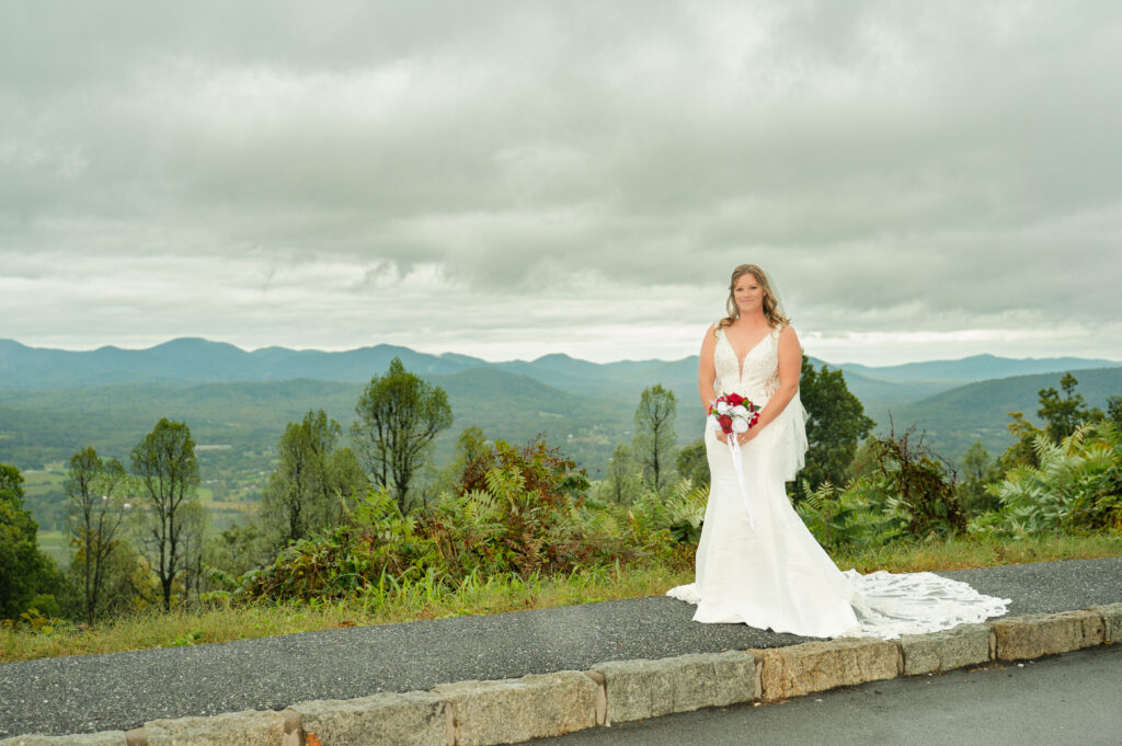 A bride in a white wedding gown with the Blue Ridge Mountains in the background.