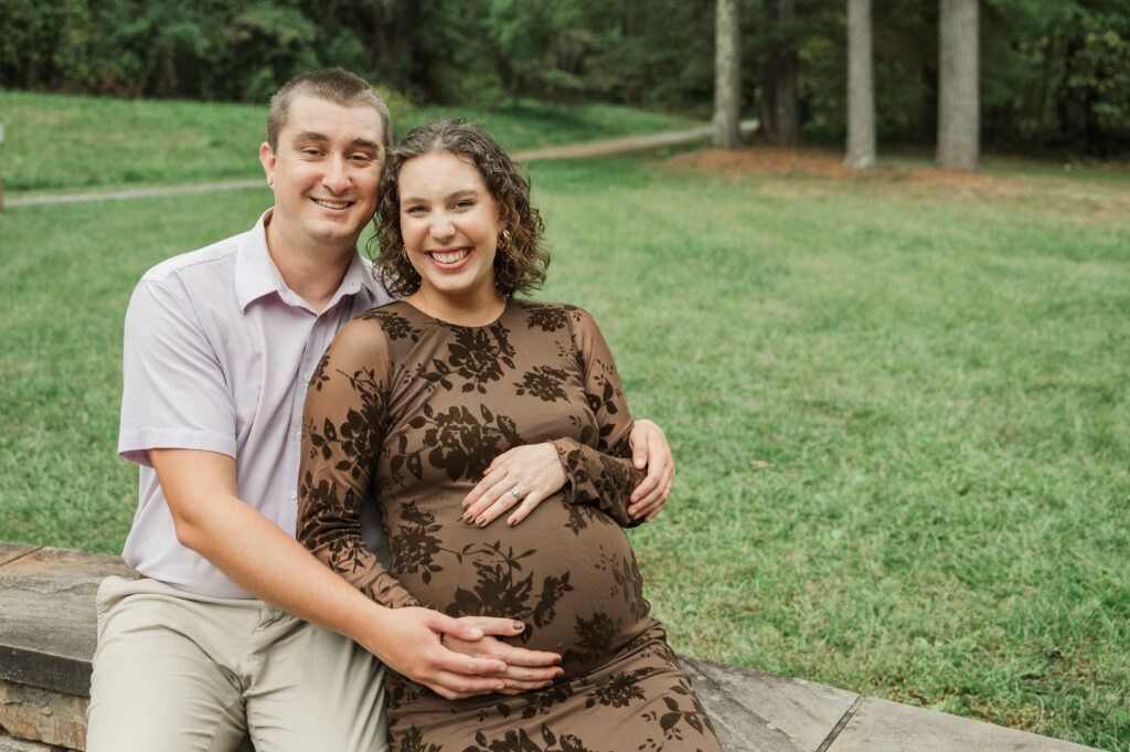 Overcast maternity session on the Saunders-Monticello Trail in Charlottesville, VA, featuring a pregnant woman in a fitted dress and her husband