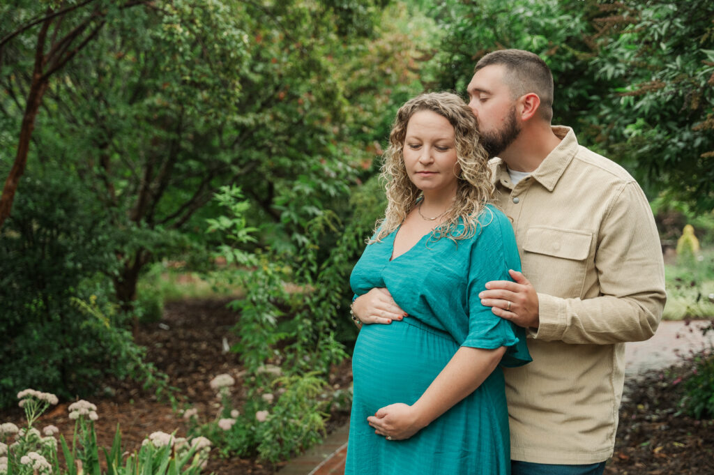 Jordan kissing Kayla during maternity session