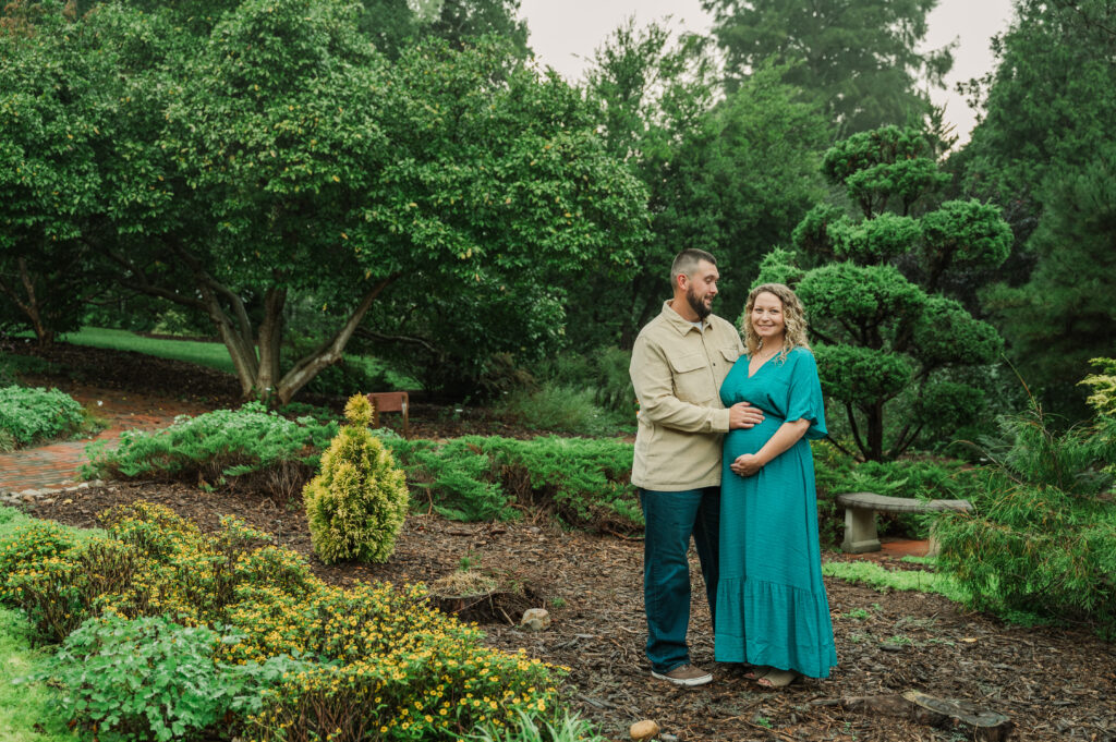 Maternity couple posing at Tanglewood Park in Clemmons NC on an overcast day.