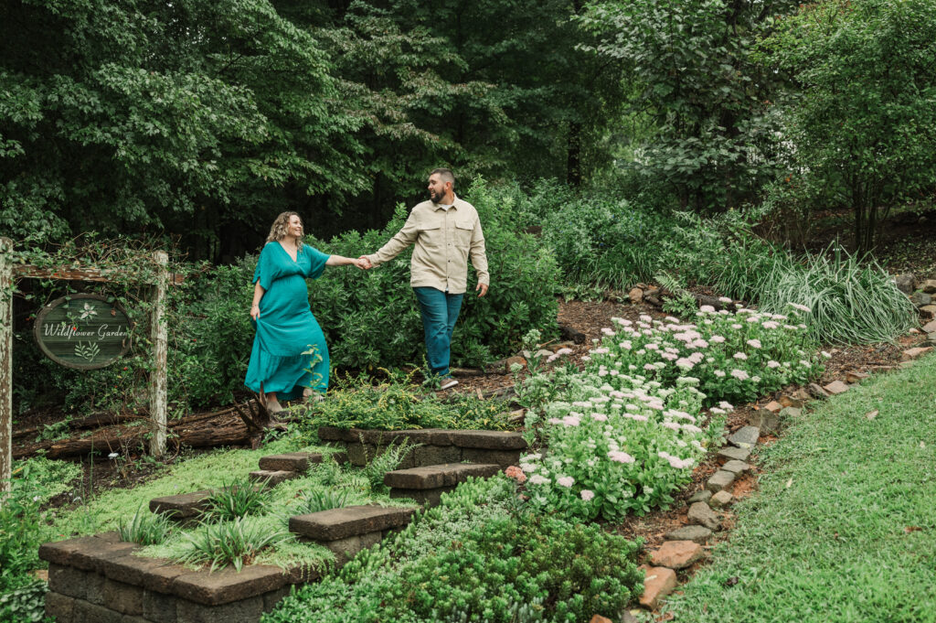 Scenic park landscape with maternity couple at Tanglewood Park near Winston-Salem.