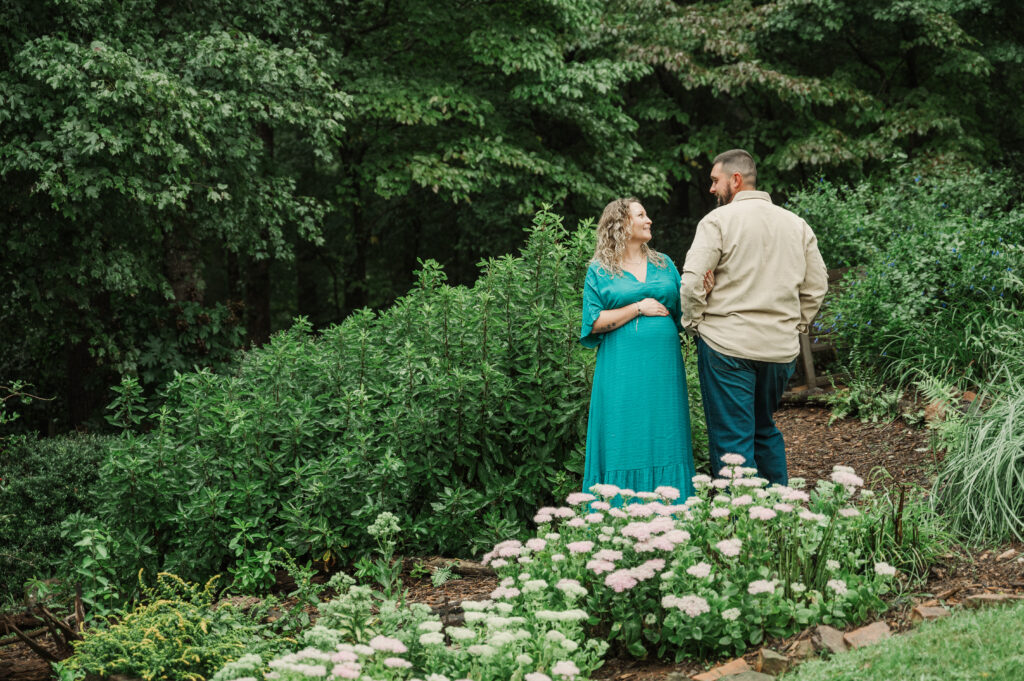 Scenic park landscape with maternity couple at Tanglewood Park near Winston-Salem.
