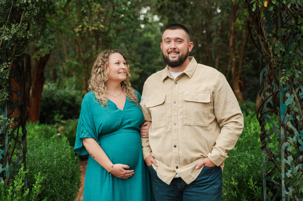 Maternity couple posing at Tanglewood Park in Clemmons NC on an overcast day.