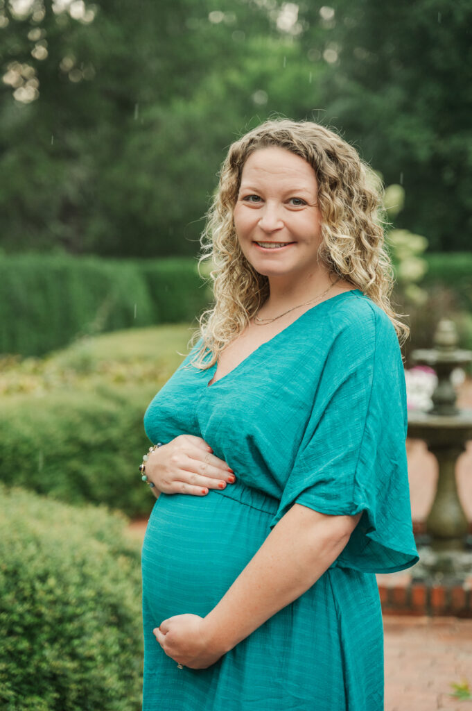 maternity portrait of an expecting mother in a green park setting.