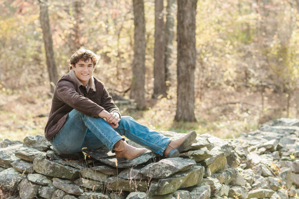 Nicholas sitting on rock wall on Blue Ridge Parkway