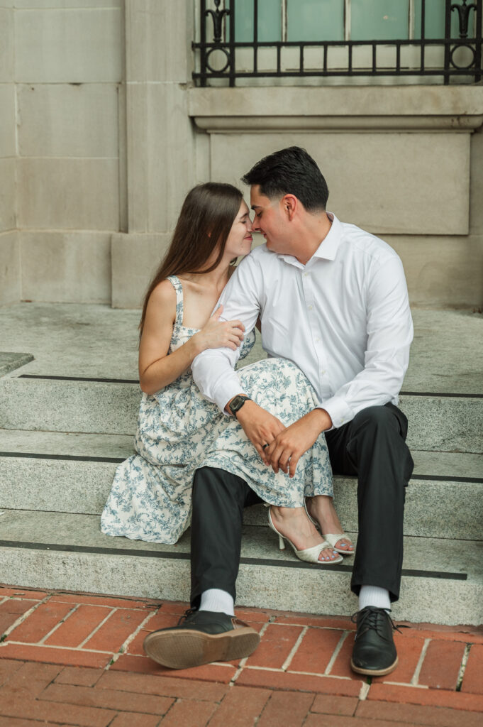 couple nuzzling on steps of the Bradbury