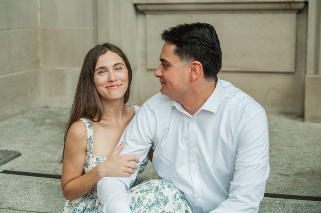 Alex gazing at Kara while sitting on steps at the Bradbury