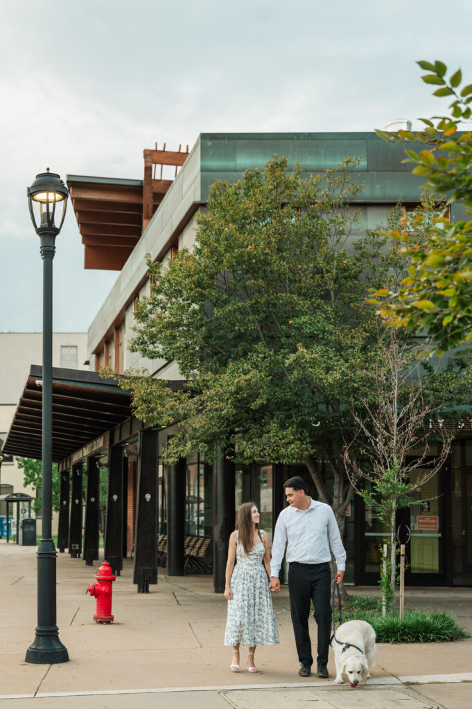 couple walking Duke their cream golden retriever at the Downtown Transit Center