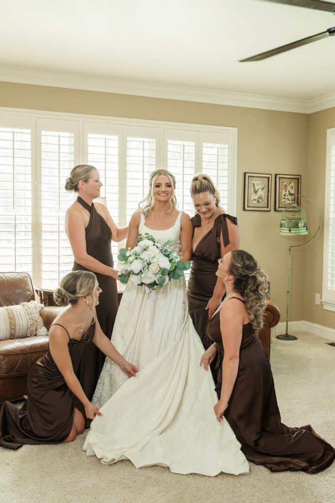 Jordan's bridesmaids fluffing the dress