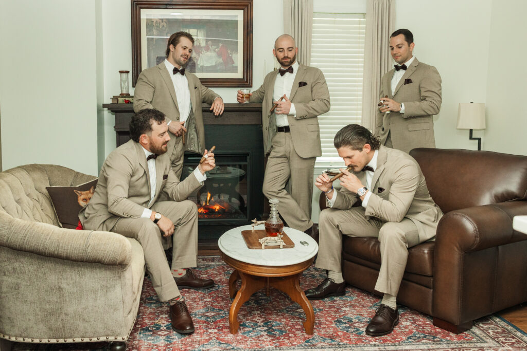 groom with groomsmen smoking cigars