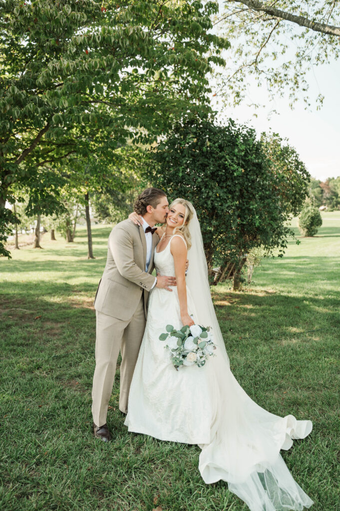 groom kissing bride after ceremony