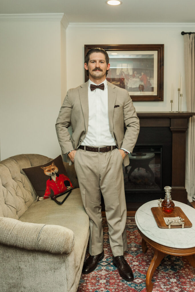 groom standing in groom's suite