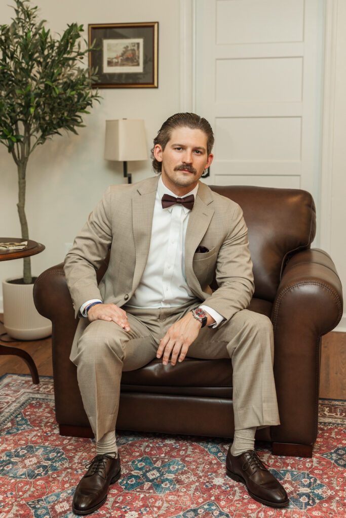groom sitting in leather chair