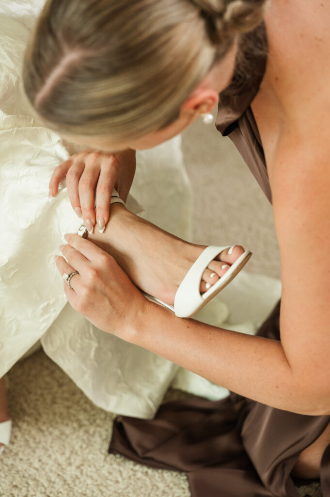 Chelsea buckling Jordan's wedding shoes