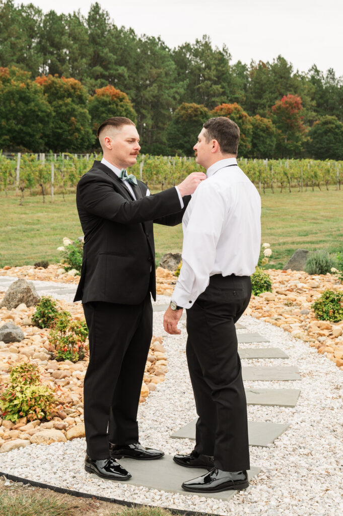 best man helping groom get ready