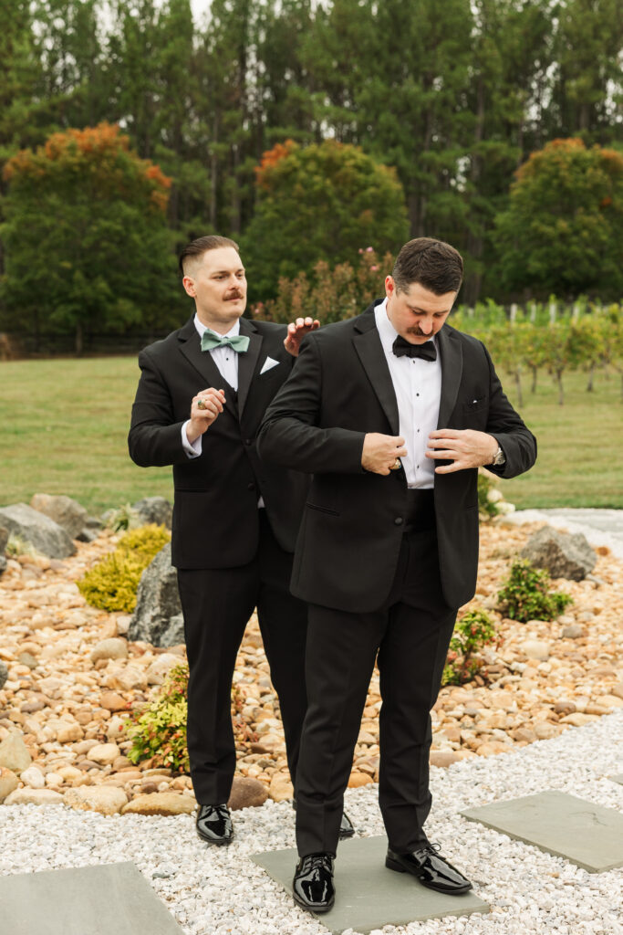 groom putting on jacket