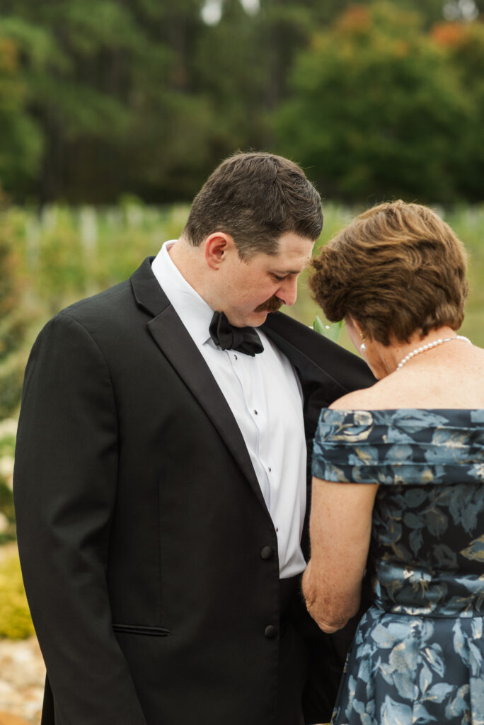 groom showing his mom the pin Maddy made for him